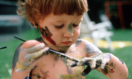 child painting himself